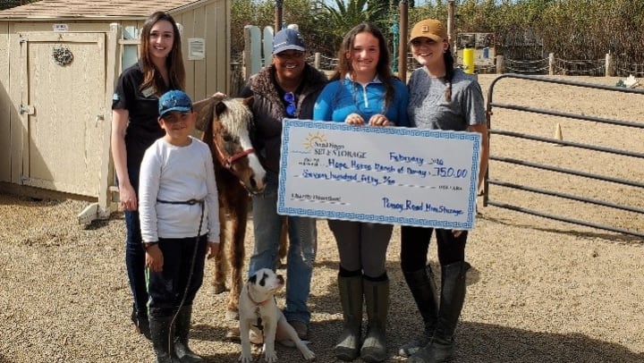Poway Road Mini Storage staff handing over the check to Hope Horse Ranch of Poway