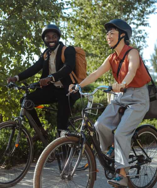 Two people riding bikes near Weinberg Commons in Washington, District of Columbia
