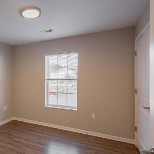 Spacious bedroom with a window pouring light in at Kershaw Greene III in Athens, Ohio