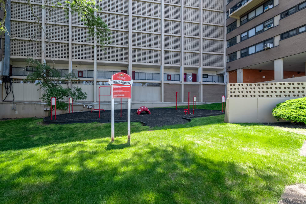 Green space with outdoor fitness stations at Riverside Towers Apartment Homes in New Brunswick, New Jersey