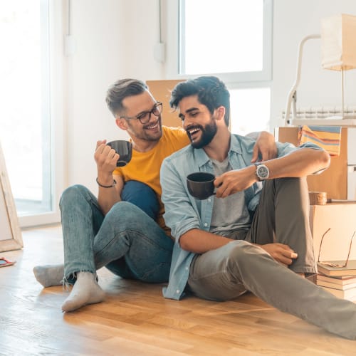 Couple relaxing in their new apartment at Milano in Portland, Oregon