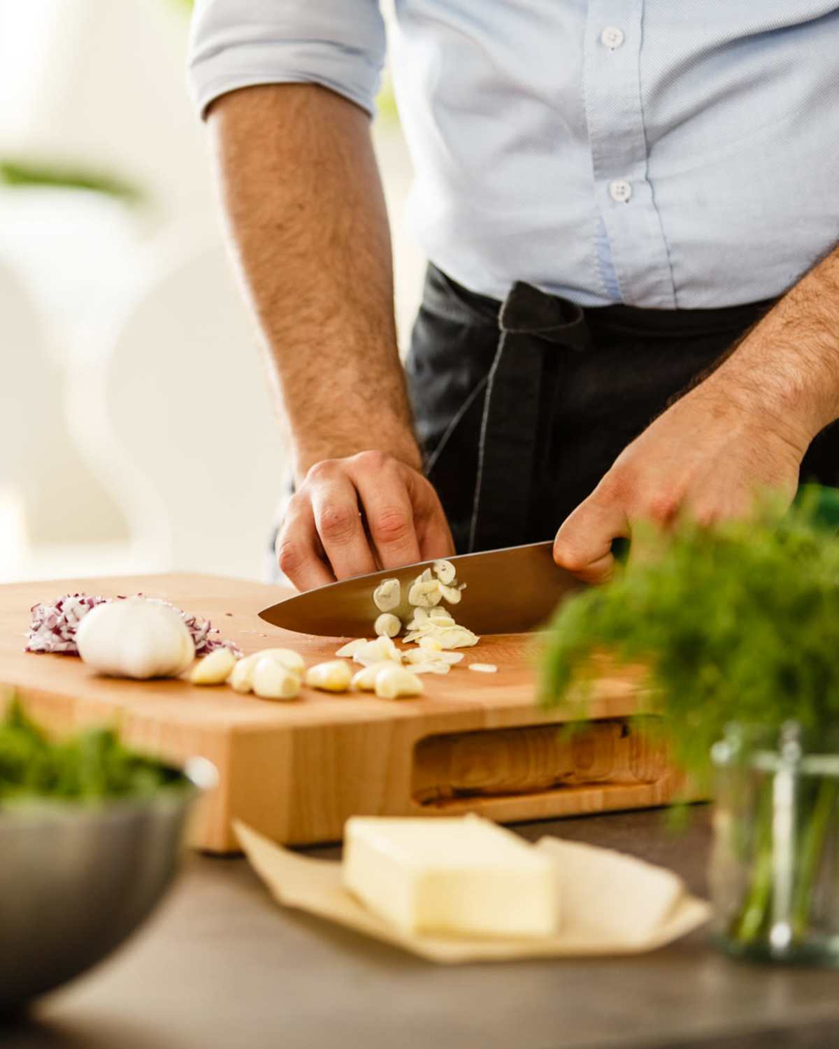 Resident chopping vegetables in his kitchen at 300 Optimist Park in Charlotte, North Carolina