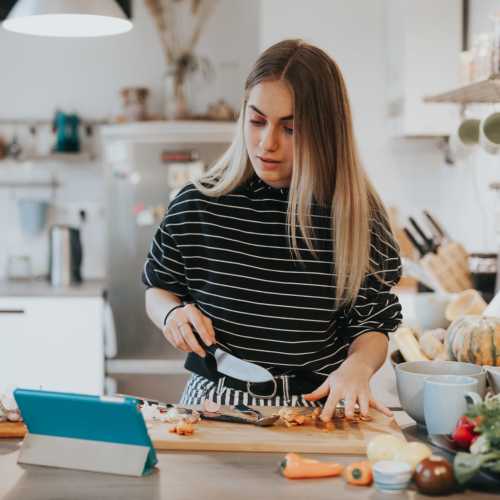 Woman preparing food in the kitchen at Gateway Terrace Apartments in Sun Prairie, Wisconsin