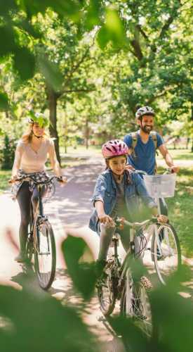 Resident family cycling at a park near Park Place Olde Town Apartments in Arvada,Colorado