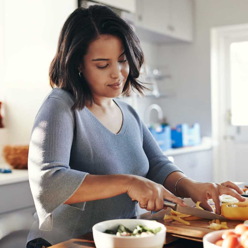 Resident cooking in a kitchen at Townsend Trace Apartments in Greensboro, North Carolina