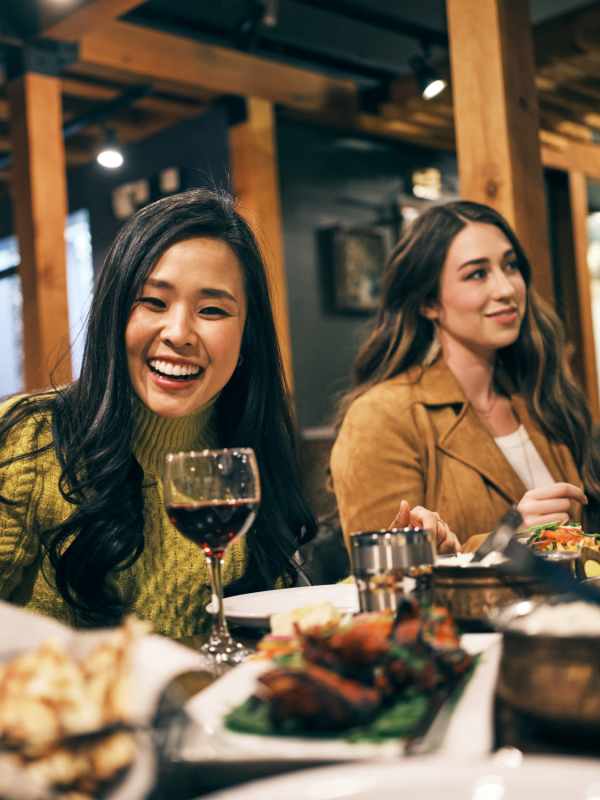 Residents with friendsin restutrant near South City Apartments in Summerville, South Carolina
