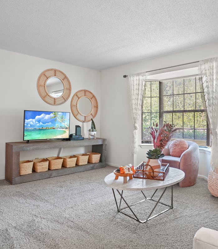 The Spacious living room with large windows at The Greens of Bedford in Tulsa, Oklahoma