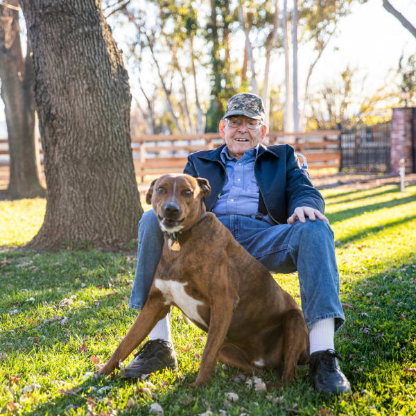A man outside with his dog at Monte Vista Village in Lemon Grove, California