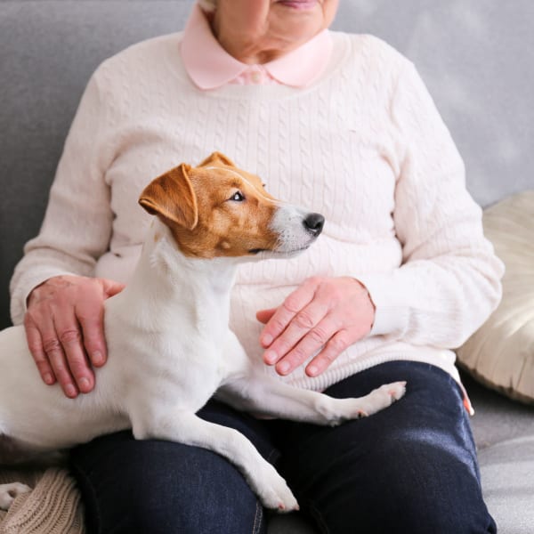 A woman and her dog at Pacifica Senior Living Bonita in Chula Vista, California