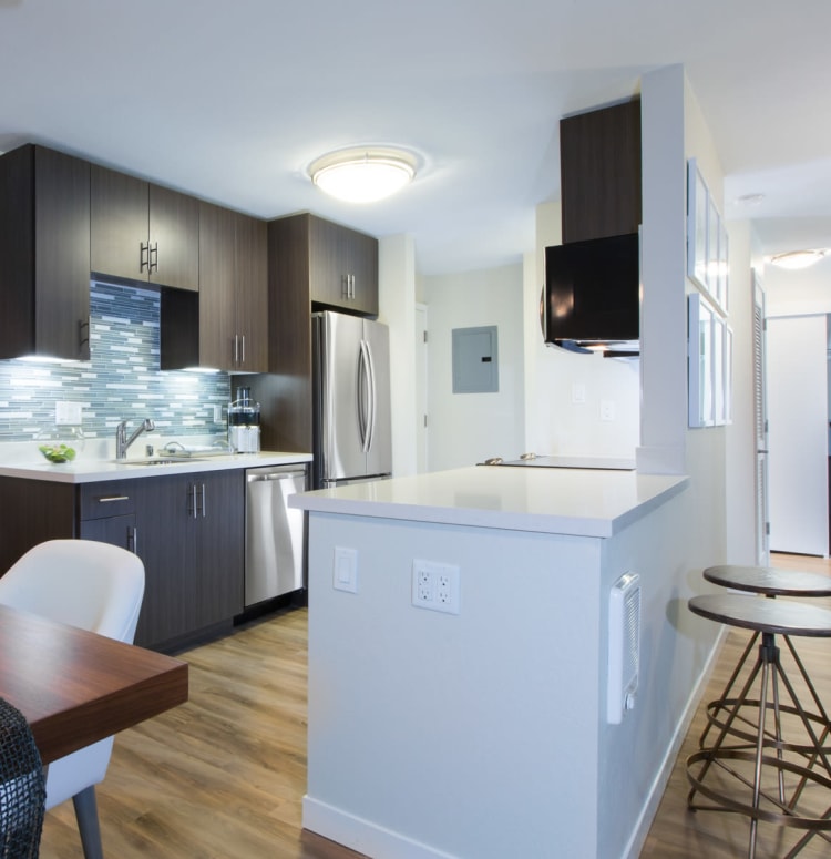 Chef-inspired kitchen with a custom tile backsplash in a model home at Sofi Belmont Glen in Belmont, California