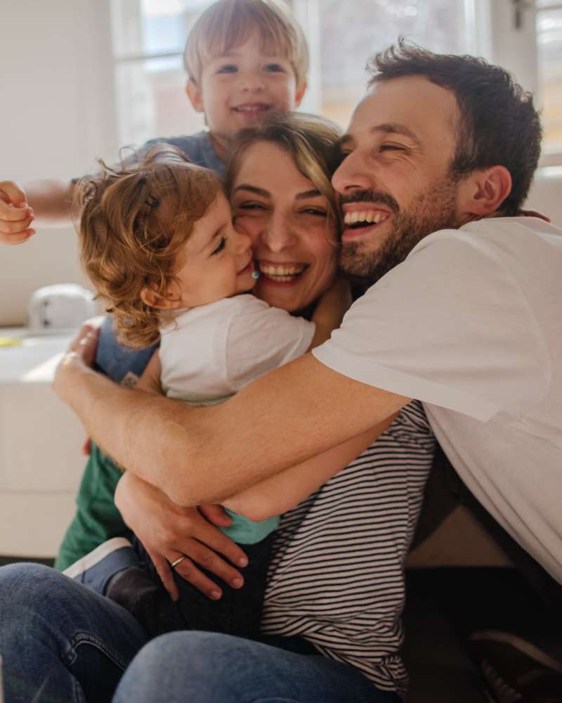 A happy resident family in their apartment home at Reedville Meadows in Beaverton, Oregon