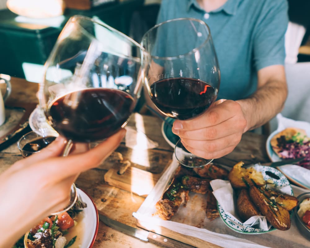 Resident eating and drinking wine together at Eagle Rock Apartments at South Nyack in South Nyack, New York