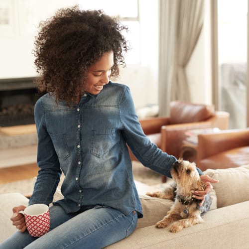 A resident playing with her dog at Town Center in Joint Base Lewis McChord, Washington