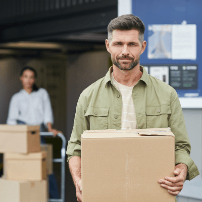 Man and woman moving boxes from a truck they rented at Towne Storage - Surprise in Surprise, Arizona