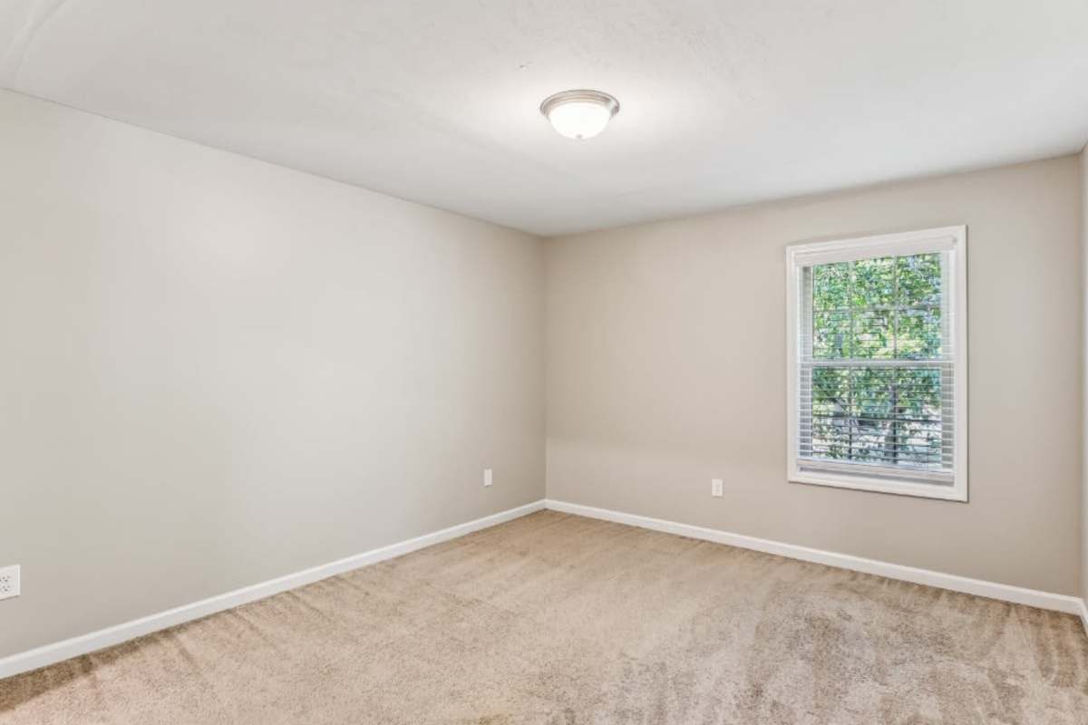 Residnet bedroom with carpeting at Ashford Place in Clarksville, Tennessee
