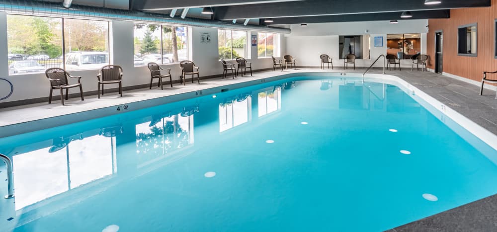 Indoor pool with plenty of windows at  Thea Apartments in Tacoma, Washington