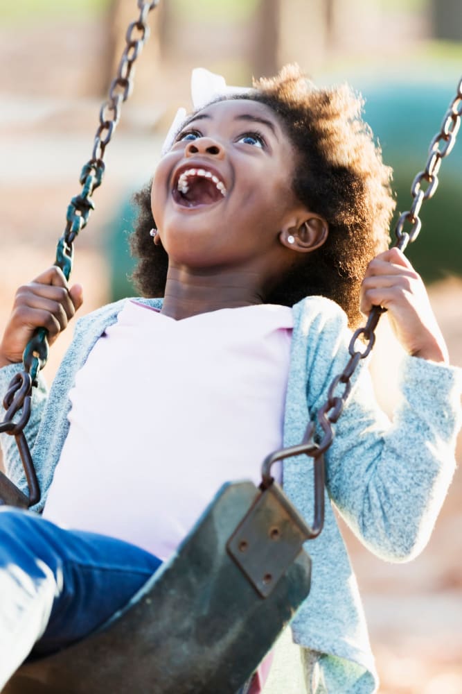 Resident child playing in the playground at Audubon Village in Bridge City, Louisiana