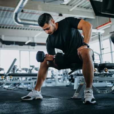 Resident lifting dumbbell weights at The Gardens, Houston, Texas