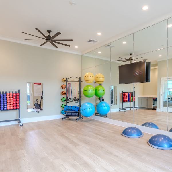 Yoga room with handweight, physi balls, bosu balls and wall of mirror at Proximity New Bern in New Bern, North Carolina