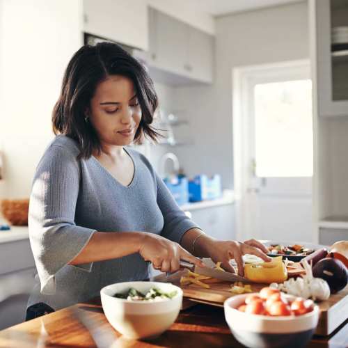 Resident chopping vegetables at Earle Residences in Chicago, Illinois