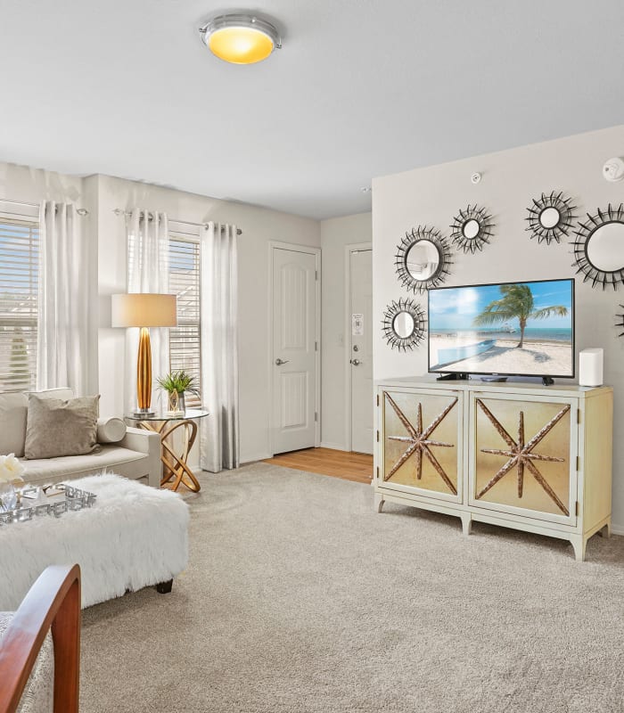 Spacious living room with large windows at Cottages at Tallgrass Point Apartments in Owasso, Oklahoma