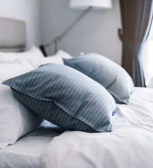 Bedroom with a cozy bed and pillows at The Kensley in Spanish Fort, Alabama