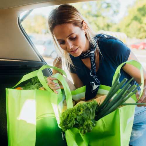 Resident loading grocery bags in the car boot near The Olivia in Homestead, Florida