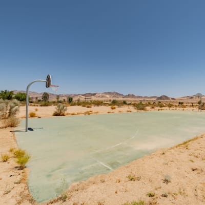 A resident at the basketball court at Two Mile in Twentynine Palms, California