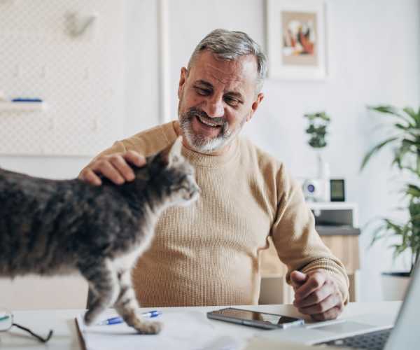 Resident spending time with his pet at The Abbey At Northlake in Riviera Beach, Florida