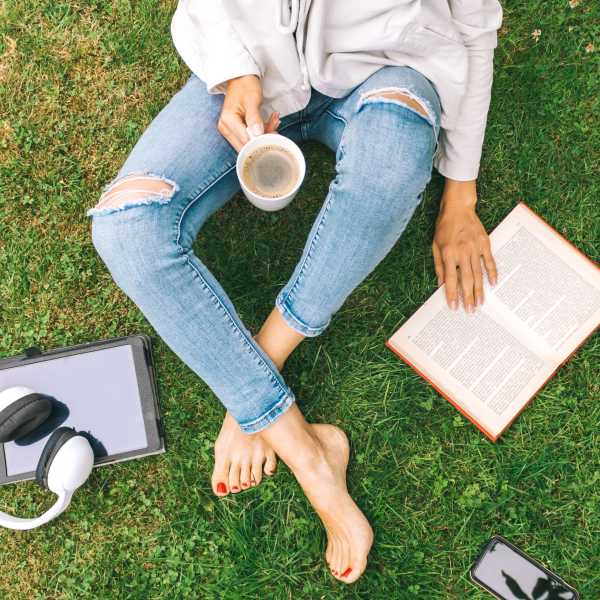 A resident studies on the lawn at Commons on Potomac Square, Sterling, Virginia 