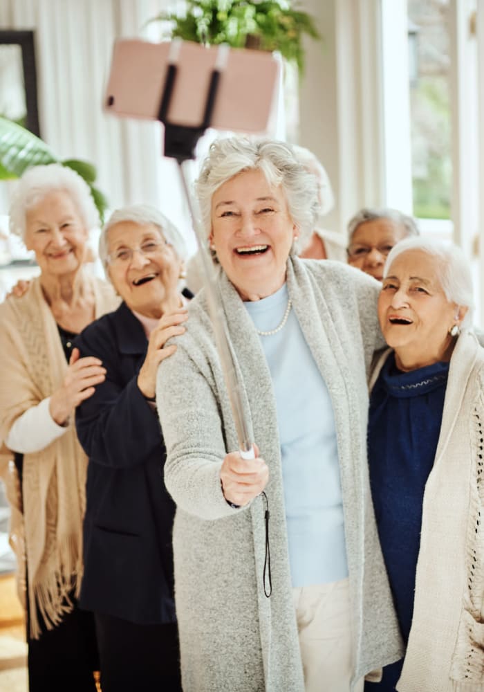 Residents blowing bubbles and making funny gestures for the camera at McLoughlin Place Senior Living in Oregon City, Oregon