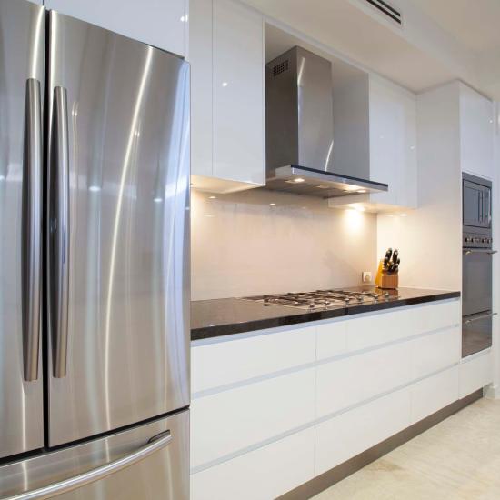 Stylish kitchen showcasing a side-by-side stainless-steel refrigerator at Koll Center in San Diego, California