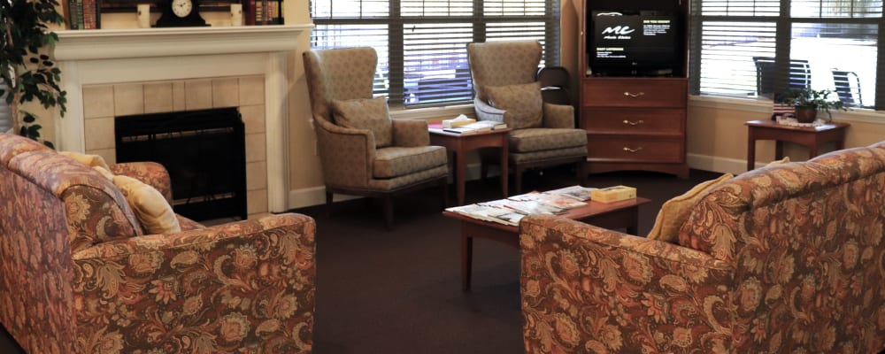 Sitting area with comfy armchairs, fireplace, television set in upscale senior living facility at The Springs at Willowcreek in Salem, Oregon