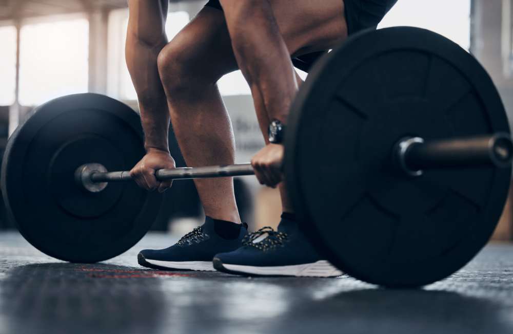 Man powerlifting in a community fitness center at Countryside Apartments in Poway, California