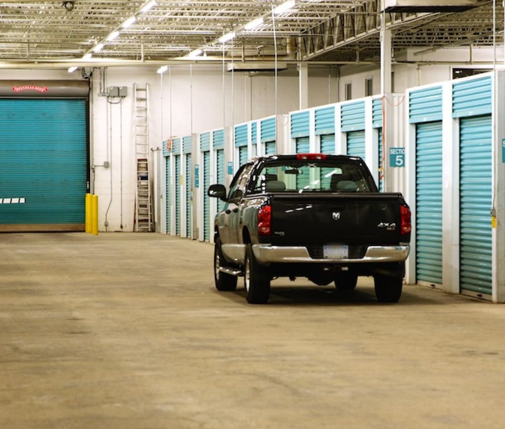 A truck parked next to an indoor unit at Advantage Self Storage in Depew, New York,