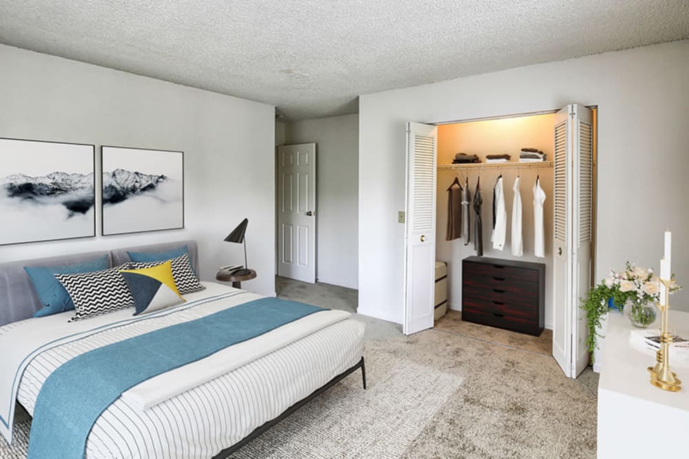 Staged bedroom with wall to wall carpeting at Knollwood Manor Apartments in Fairport, New York