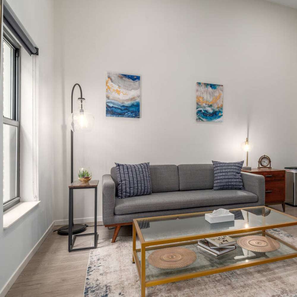 Bright living room with large windows at Euclid Grand in Cleveland, Ohio,  