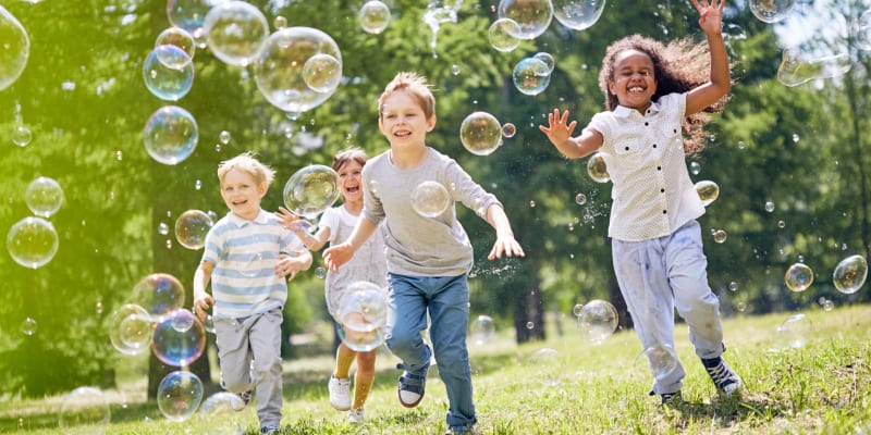 Children playing with bubbles at a park near Broadmoor in Joint Base Lewis McChord, Washington