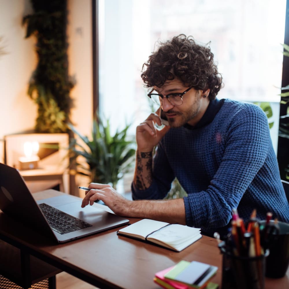 Resident working on his laptop at Forest Cove in Doraville, Georgia