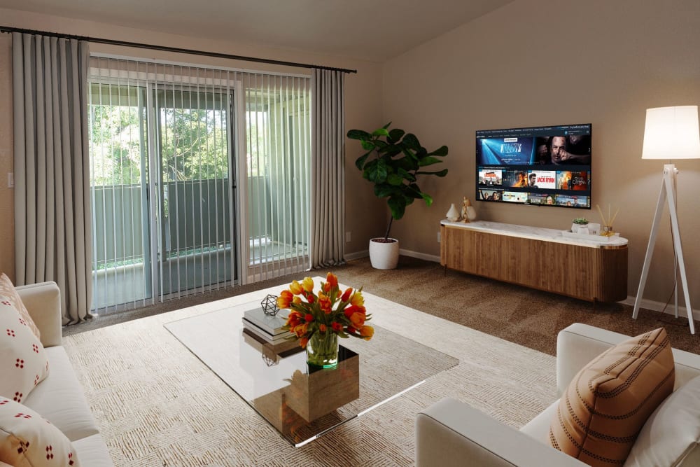 Spacious living room with balcony at Castle Hill Apartments in Sacramento, California