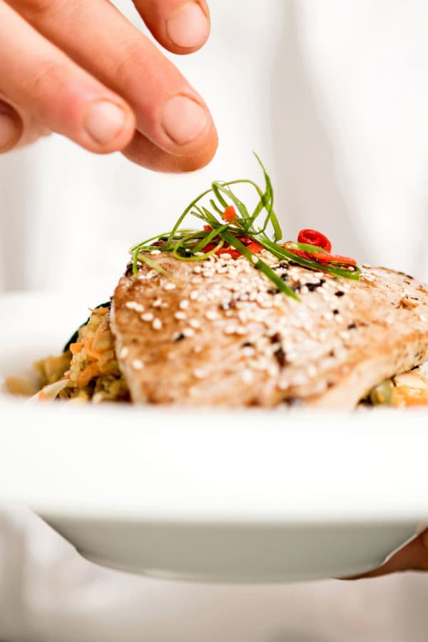 Chef garnishing the dish at a restaurant nearby The Abbey at Briargrove Park in Houston, Texas