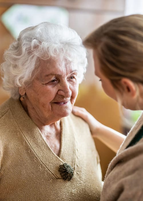 Staff member greeting a resident at Grand Villa of Altamonte Springs in Altamonte Springs, Florida