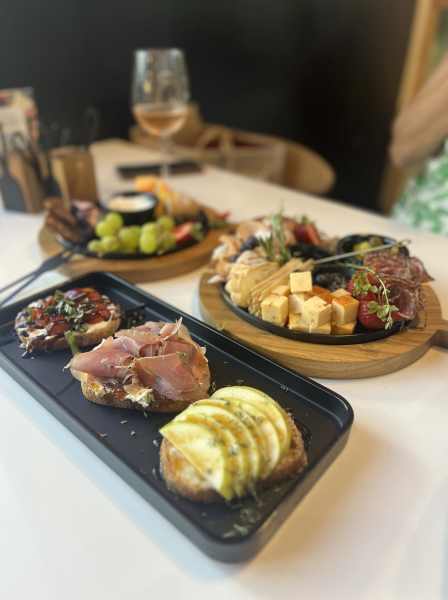 Fresh charcuterie boards and artisan appetizers served at The Landing at Woodland Lakes in Conroe, Texas, offering a delightful dining experience.