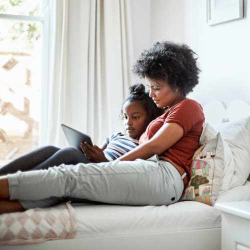 A mother and daughter reading together at Silver Strand II in Coronado, California