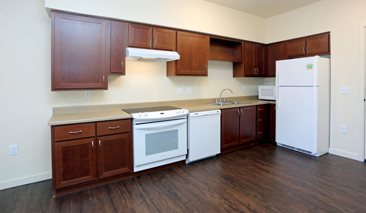Kitchen with white appliances at Traditions at Colorado Springs in Colorado Springs, Colorado