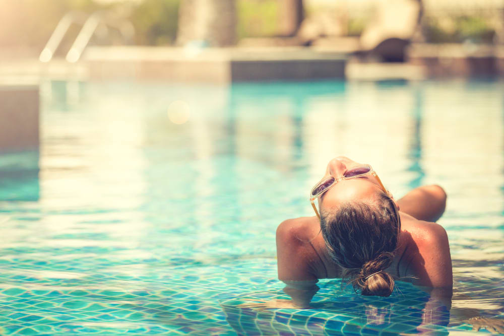 A resident relaxing in a swimming pool at Osprey Point in Virginia Beach, Virginia