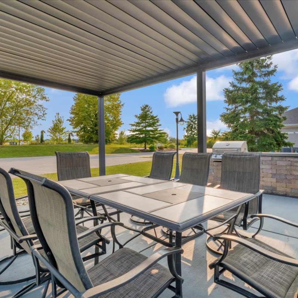 Covered outdoor patio with dining area at River Club in Holland, Michigan