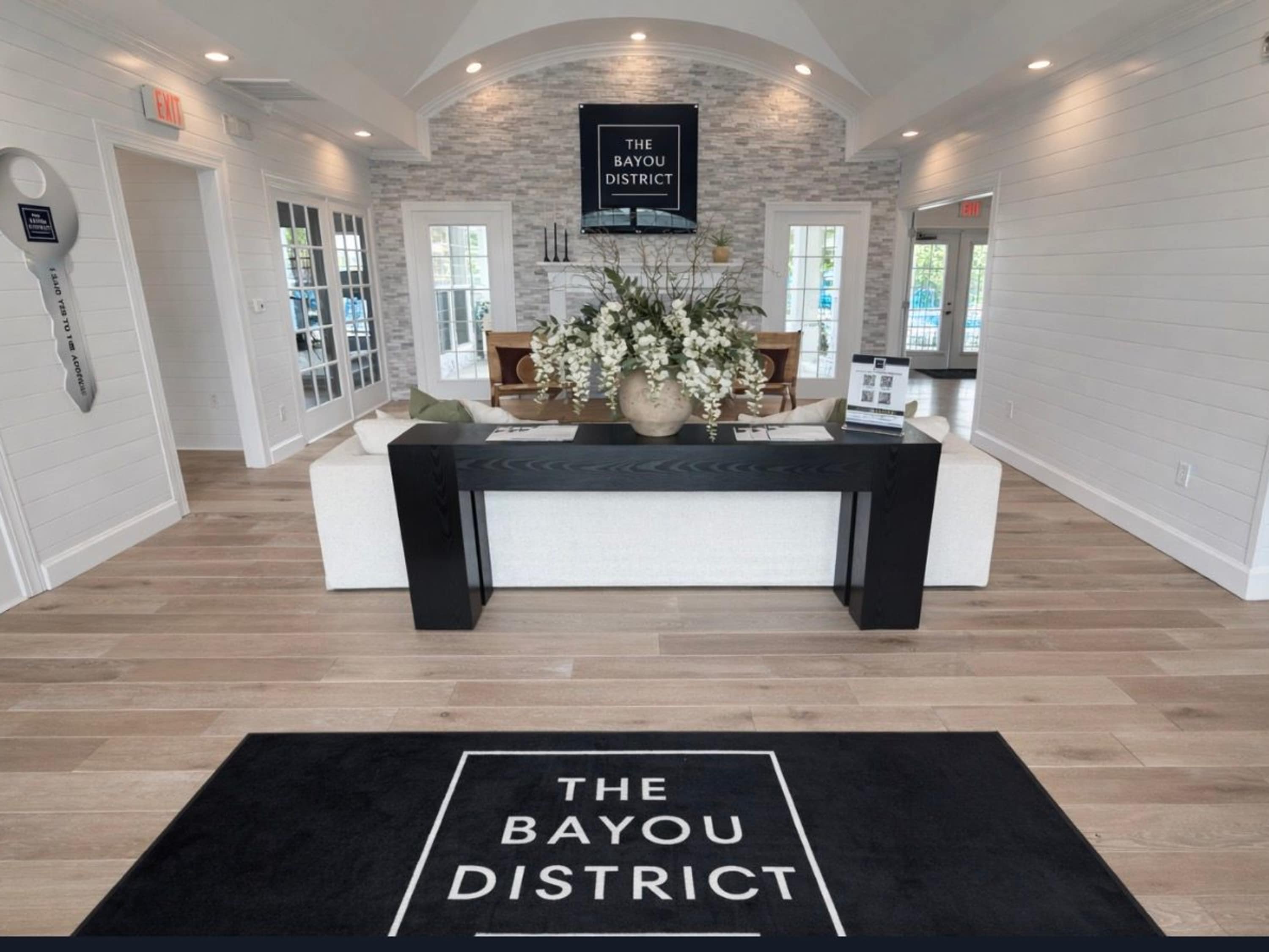 Apartment clubhouse lobby with seating area at The Bayou District in Gulfport, Mississippi