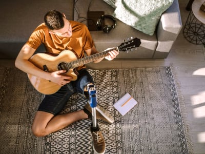 Man playing guitar at Broadway Towers in Concord, California