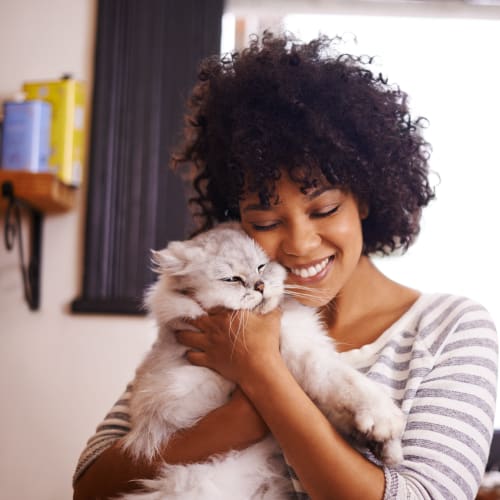 A residnet holding her cat at Seaside Village in Oceanside, California